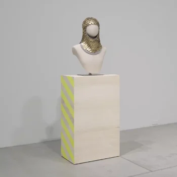 Maria Hupfield (Wasauksing First Nation [Anishinaabe]) Golden Dollar (Sacagawea), 2018 industrial felt hood with 500 U.S. Sacagawea $1 coins, sewing mannequin, painted plinth 171 × 56 × 46 cm (67 5/16 × 22 1/16 × 18 1/8 in.) Collection of the Art Gallery of Ontario, Purchase, with funds from Canada Council York Wilson Endowment Award and Indigenous and Canadian Fund, 2021, 2021/94 © Maria Hupfield. Photo: AGO